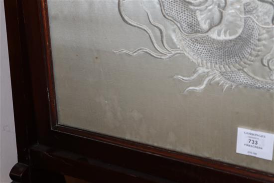 A Chinese couched and embroidered silk dragon firescreen W.69cm